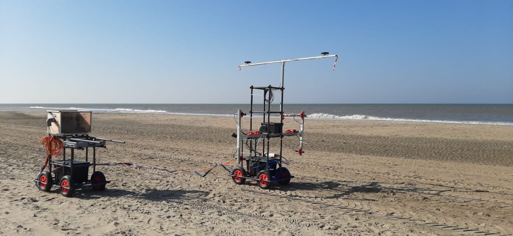 Onshore cable detection carts with sensor arrays positioned on a sandy beach for landfall and shoreline surveys