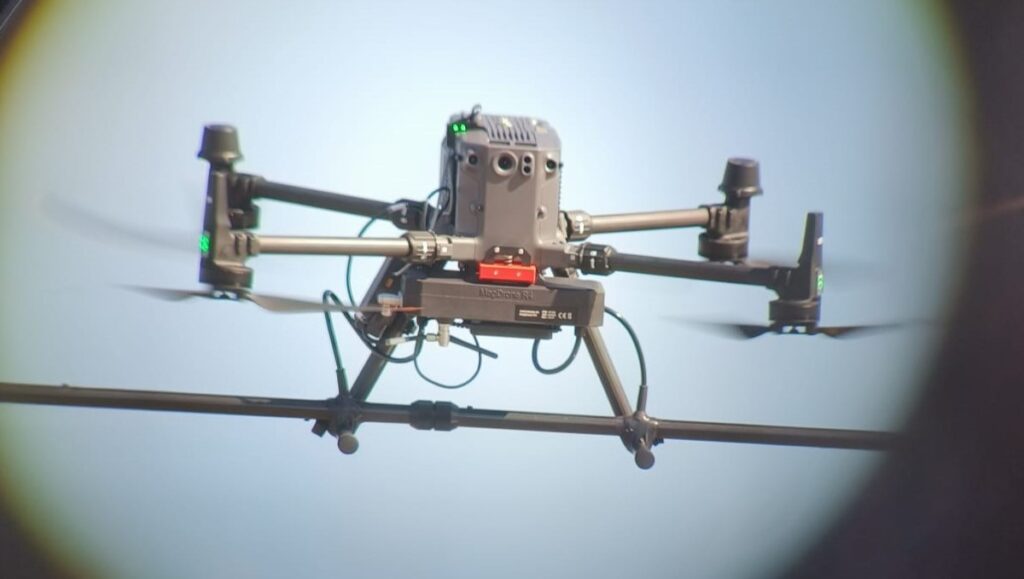 High-precision DJI M350 equipped with magnetometre sensors in flight, used for cable detection in intertidal or onshore environments.