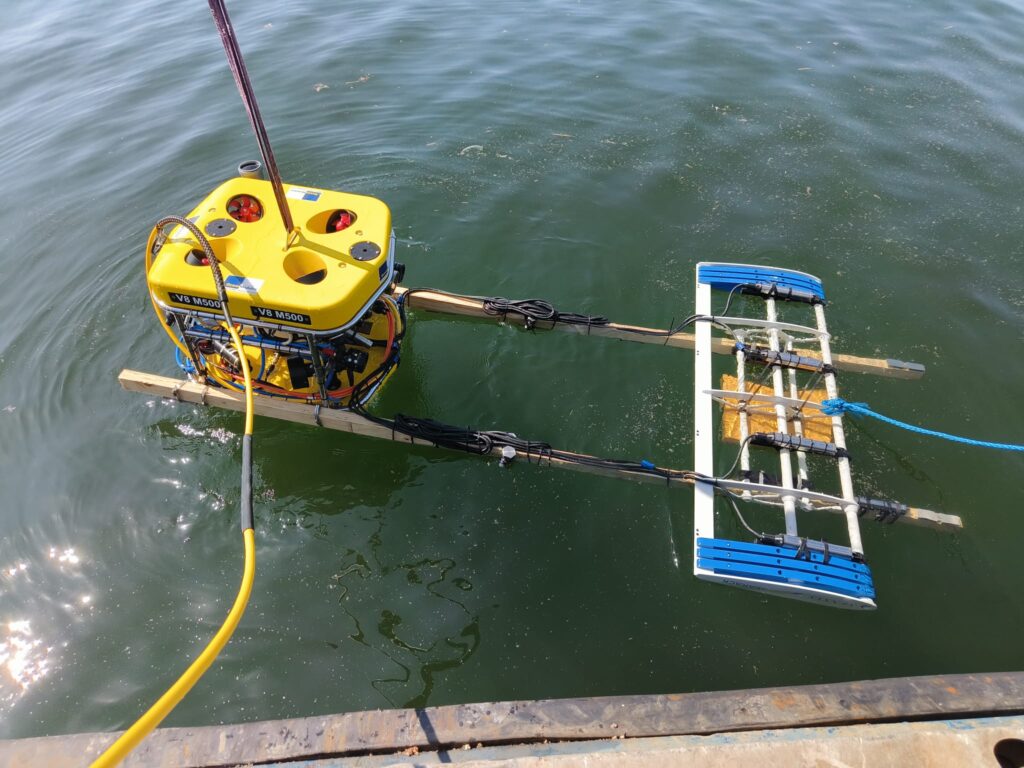 Remotely Operated Vehicle (ROV) deployed in the water with mounted sensor frame for subsea cable tracking and monitoring.